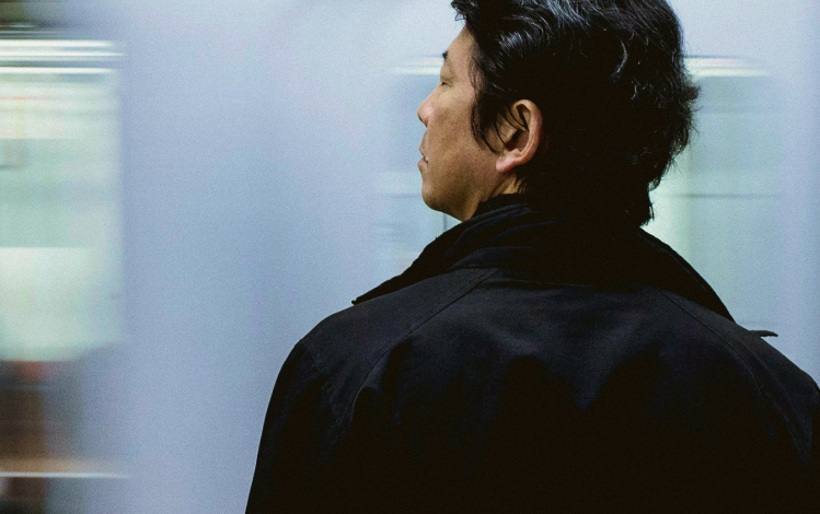 Man standing in front of moving train