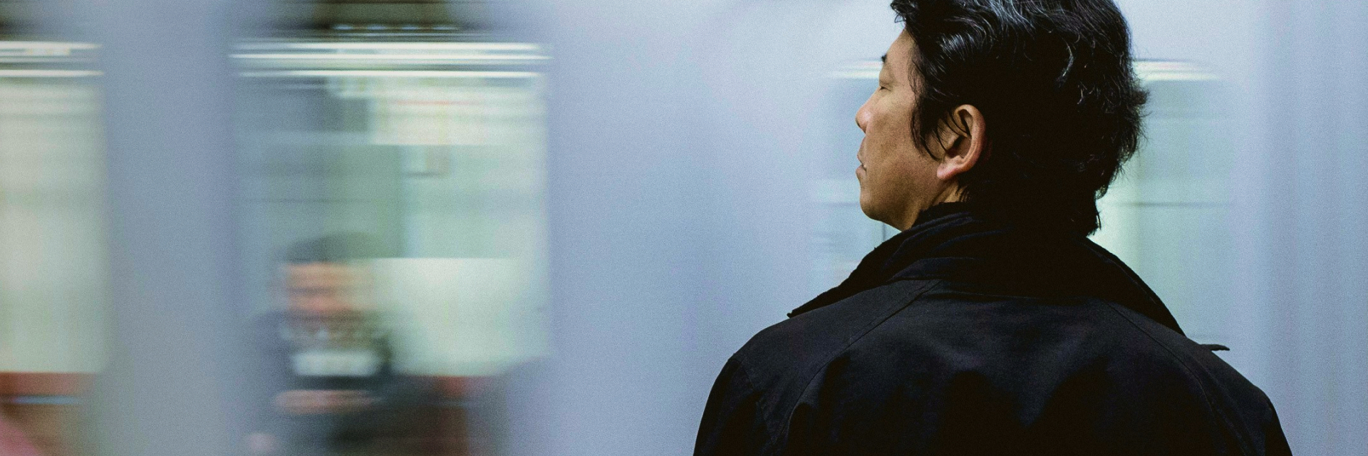 Man standing in front of moving train